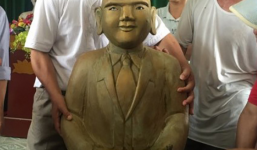 Phát hiện pho tượng lạ mặc vest màu vàng nằm dưới đầm tôm